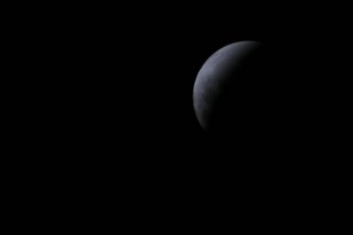the crescent is visible in the dark sky