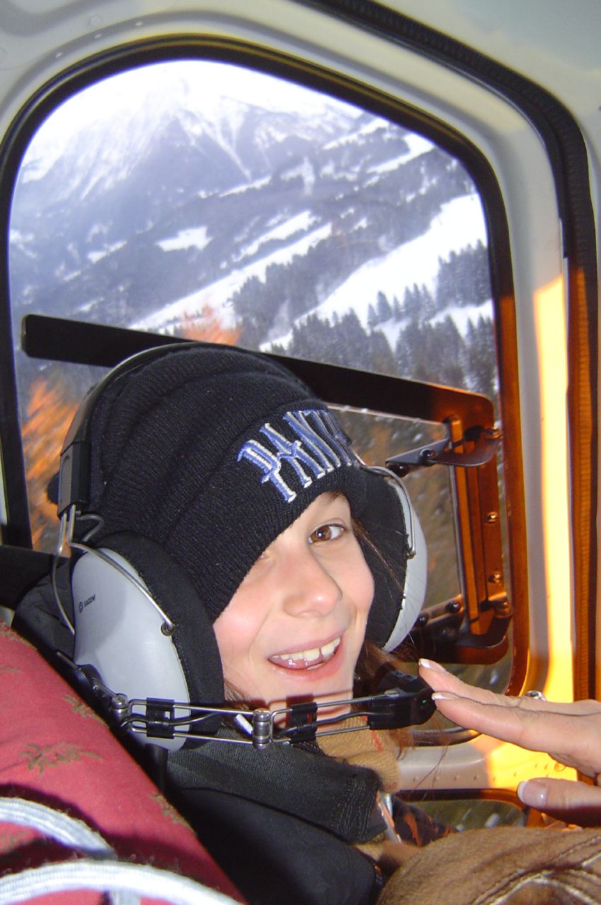 a woman smiling and sitting inside an airplane