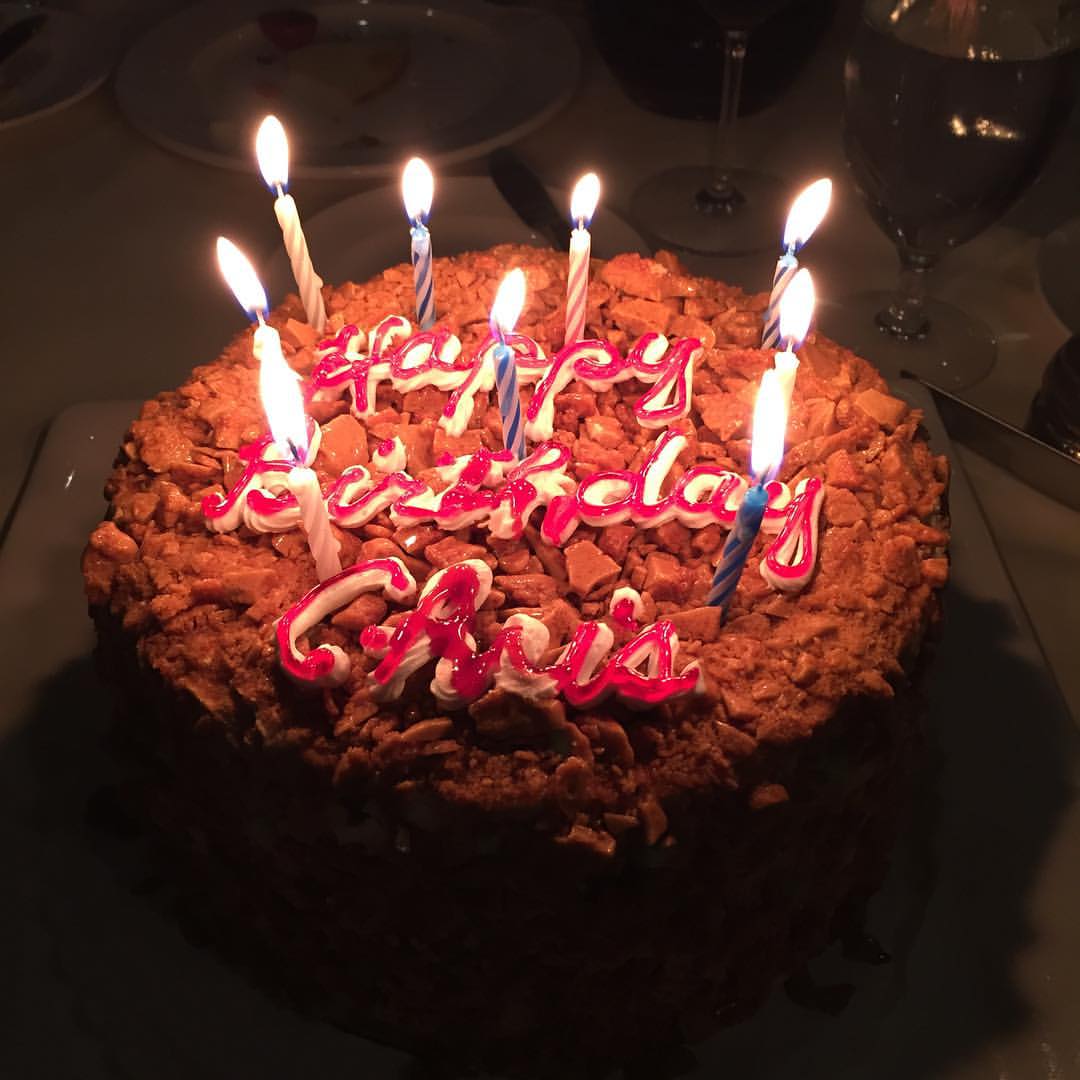 a cake with candles and letters on it
