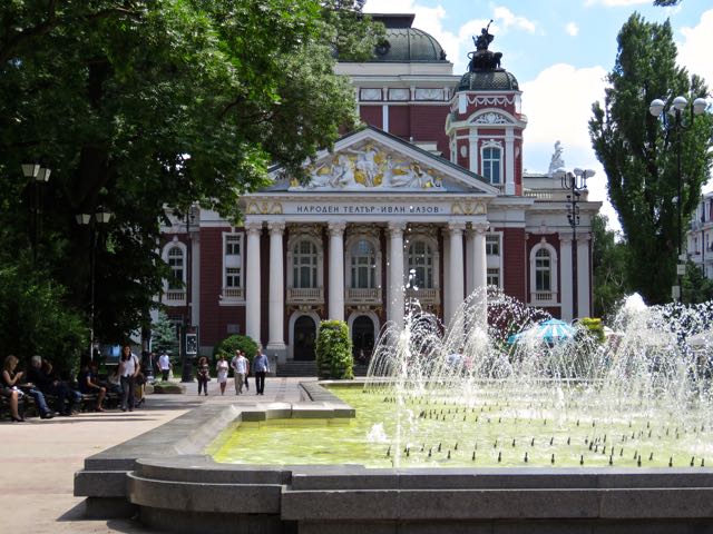 an old building with a fountain in the center