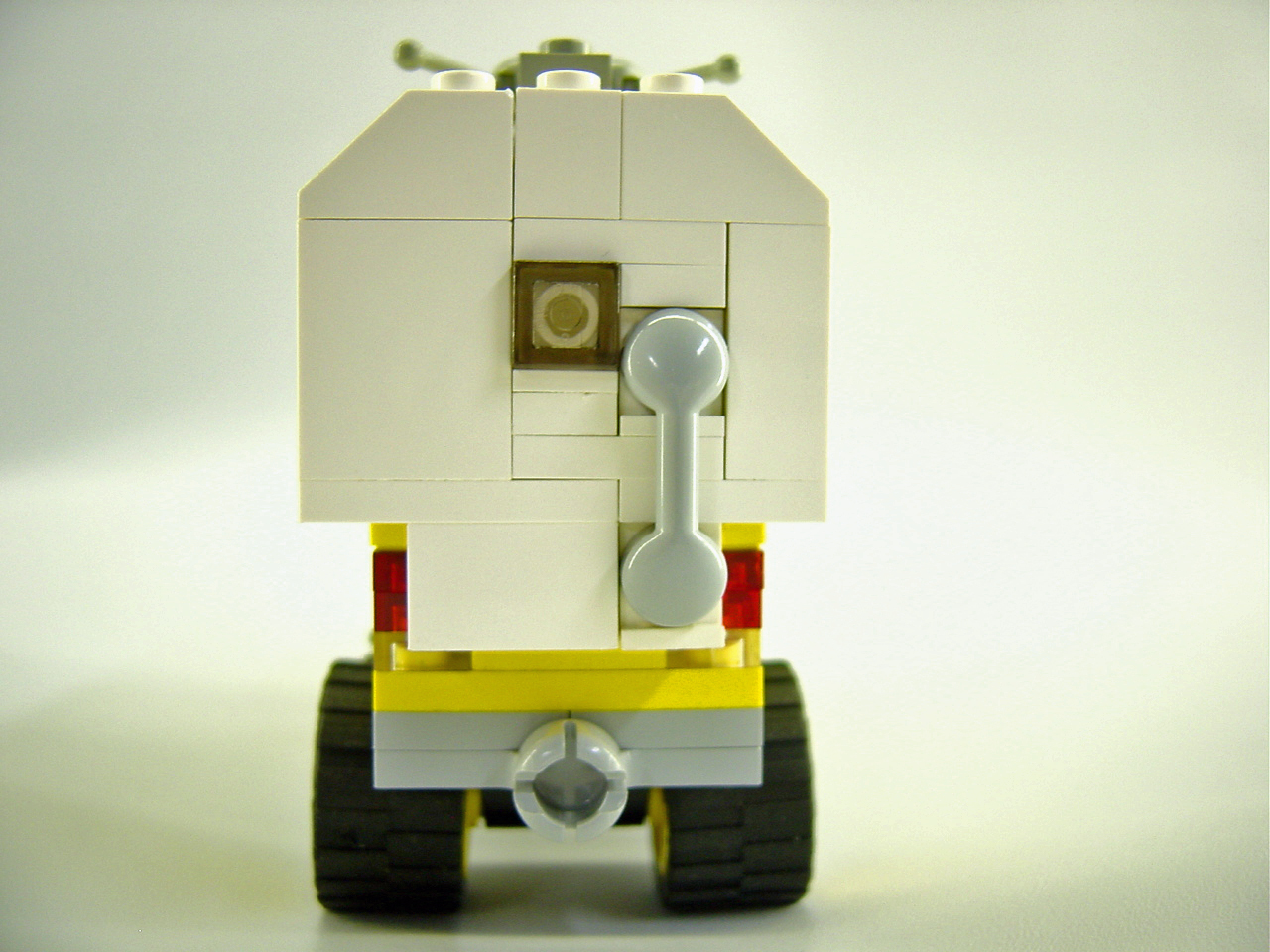 there is a white lego truck that has a yellow and black bed