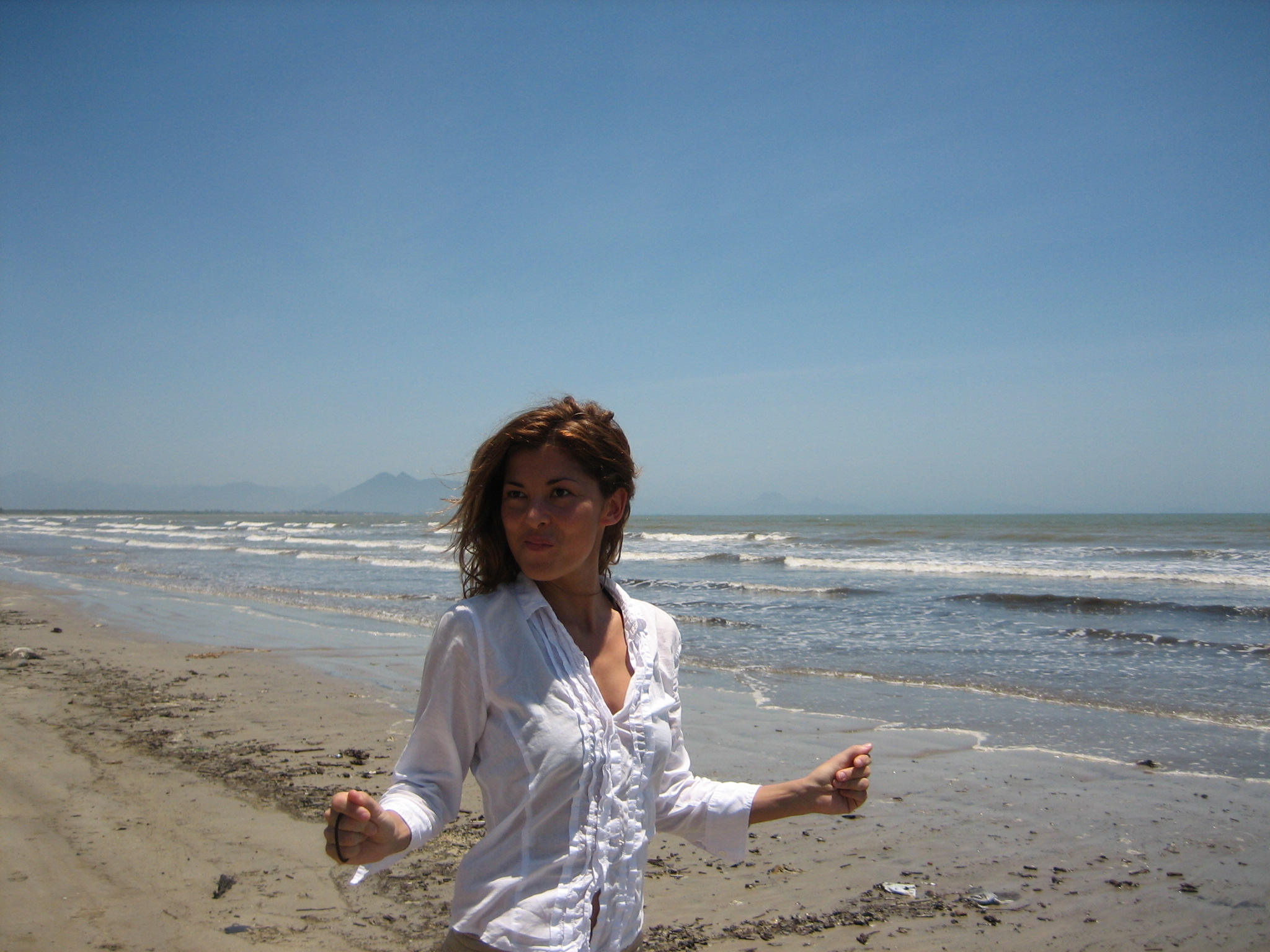 a  on a beach running towards the water