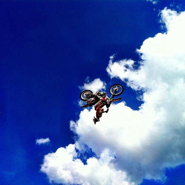 a man doing a trick on his bike in the air