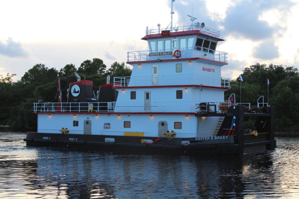 there is a white and red ferry boat on the water