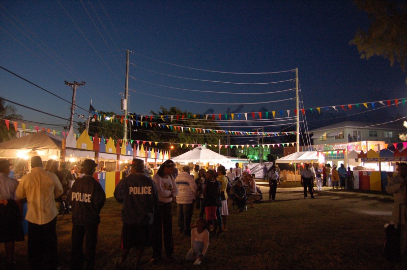 some people are at a carnival with colorful flags