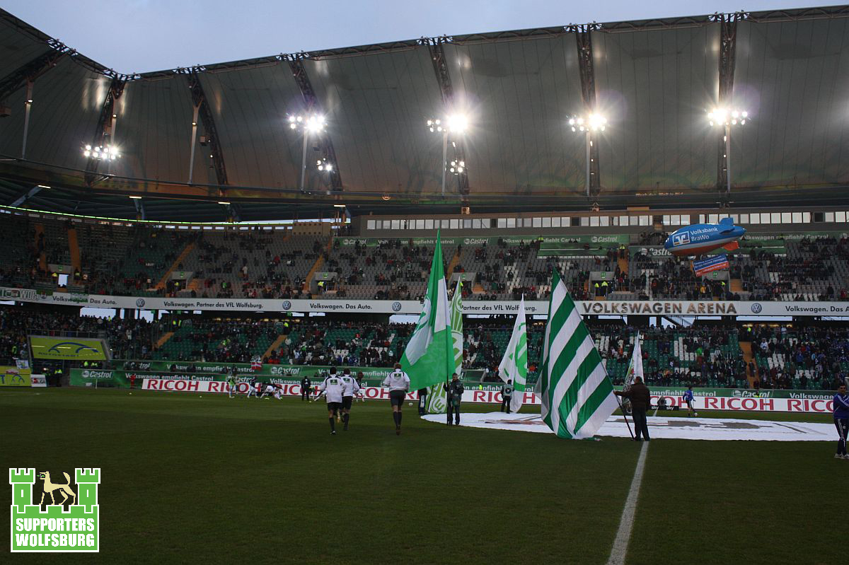 the stadium is filled with green and white flags