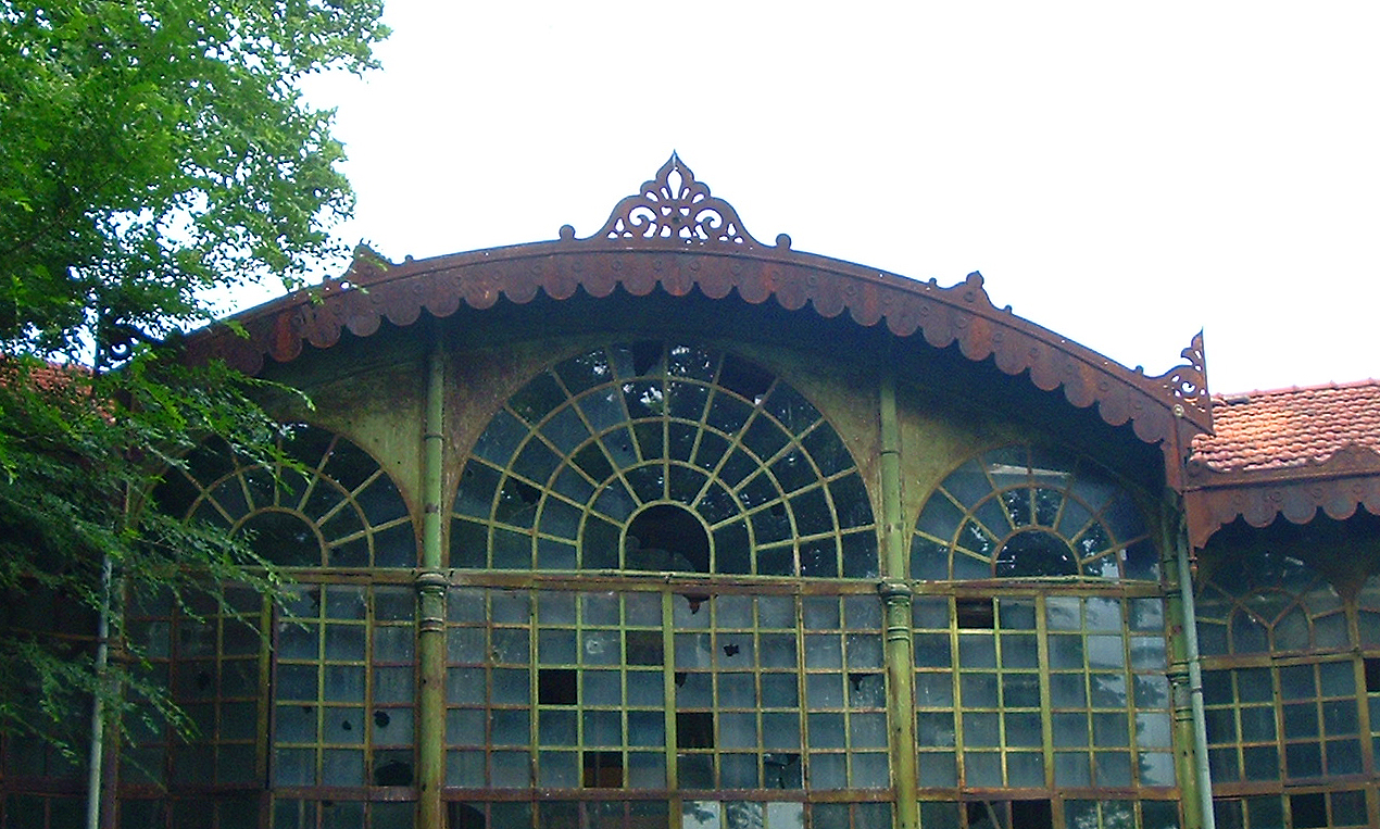 an old building has glass doors and tiled roof