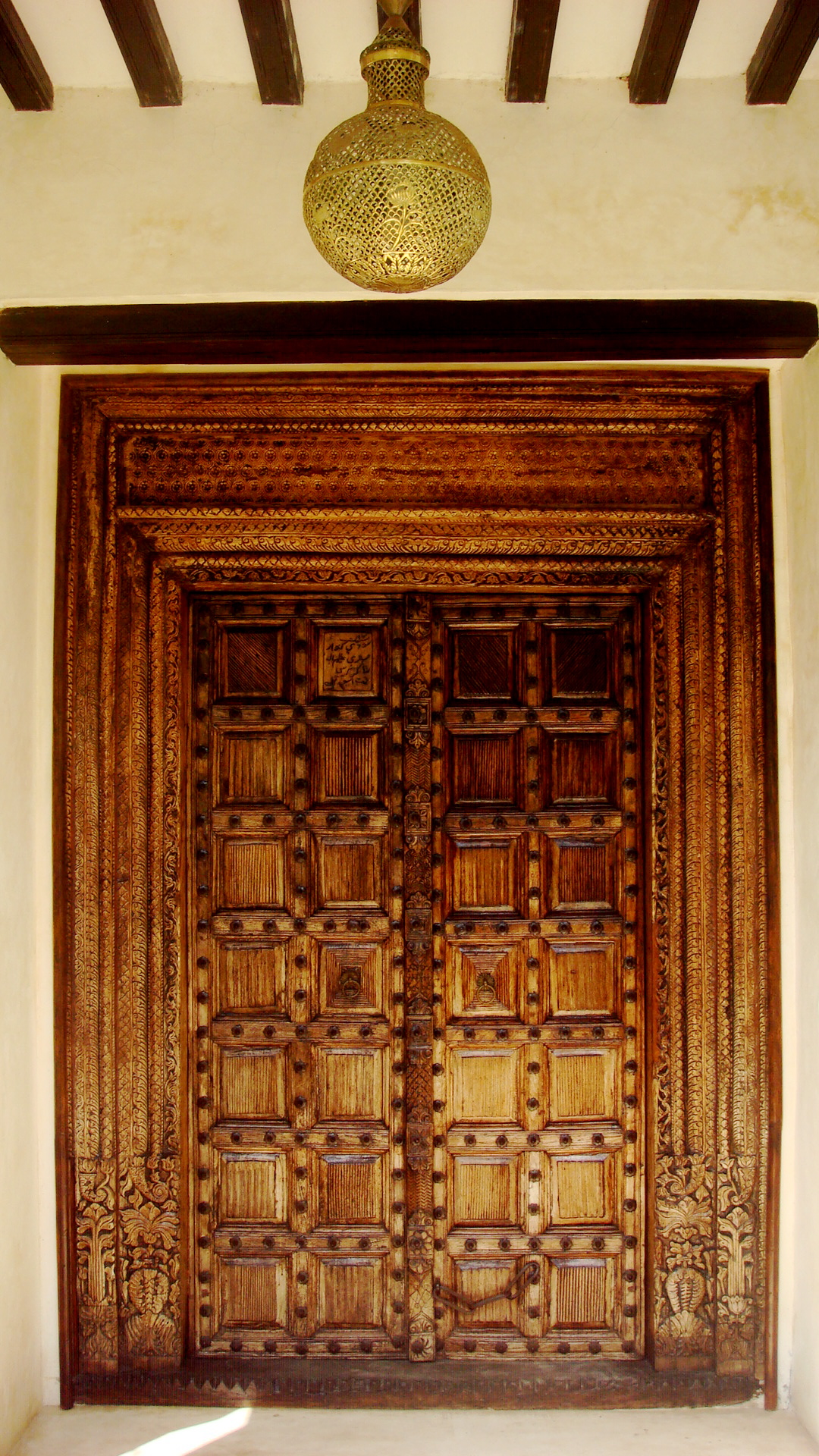 the intricately designed wooden door and the light shine