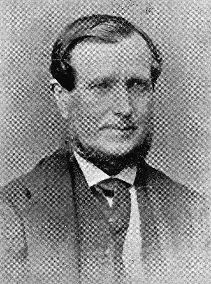 an old fashioned portrait shows a man in suit and tie
