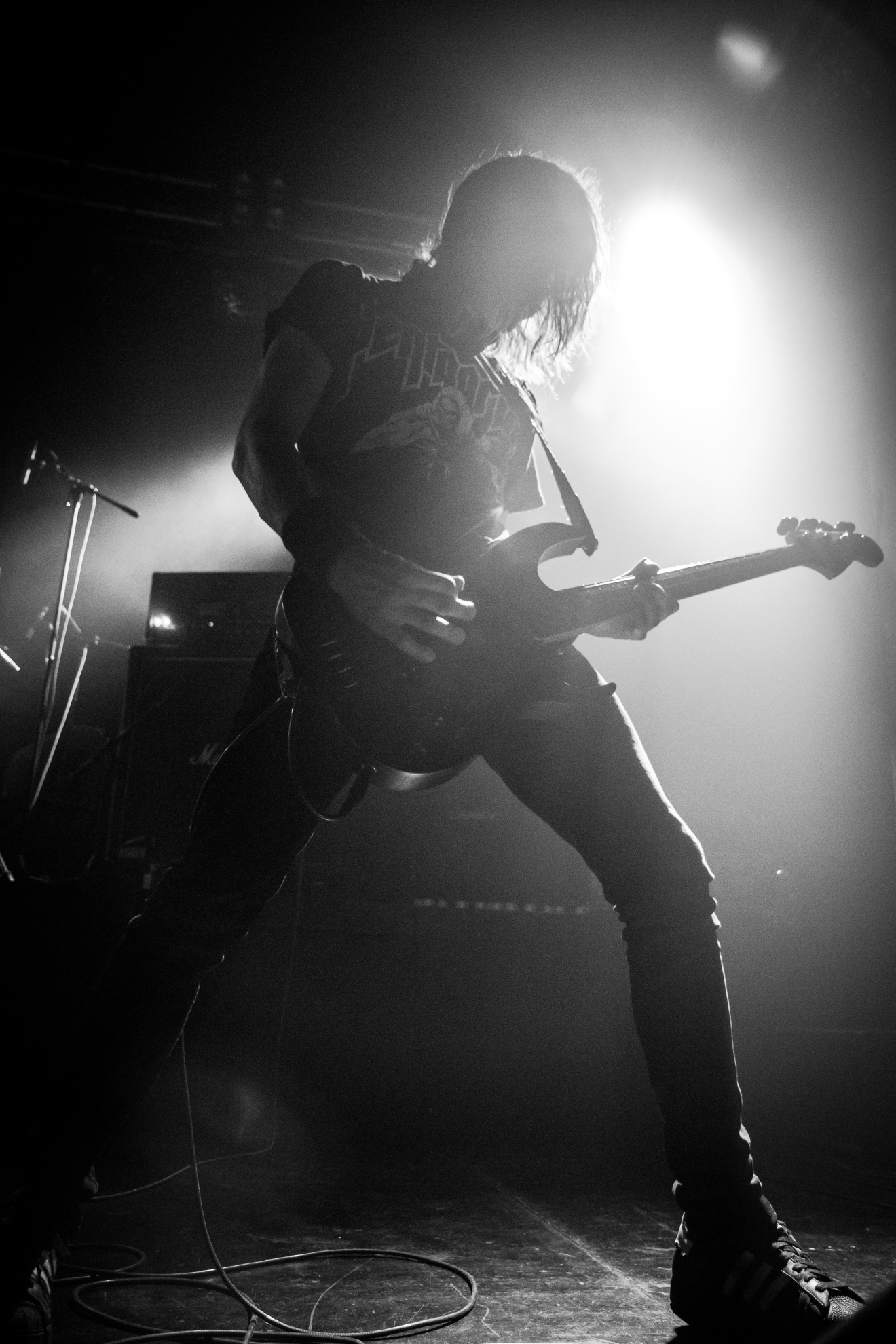 a person with a guitar on stage