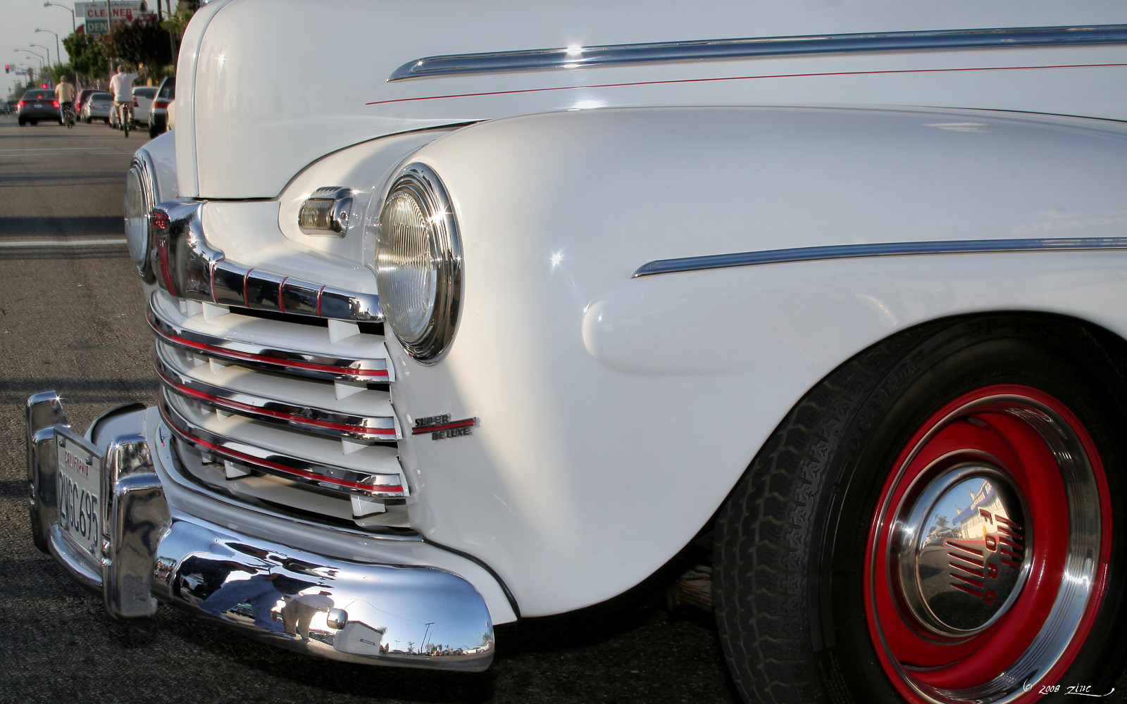 a close up of the front end of a white antique truck