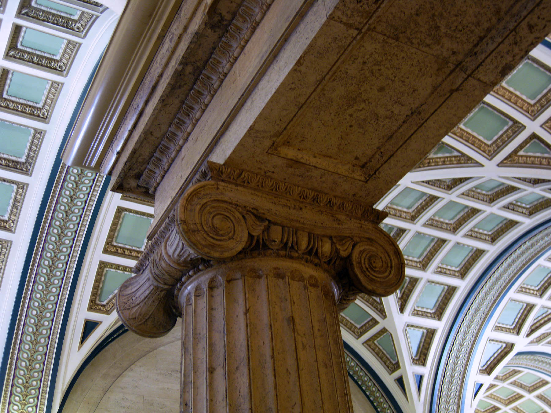 a pillar with two marble columns and a clock at the base