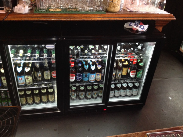 a row of beverage bottles in a wine shop