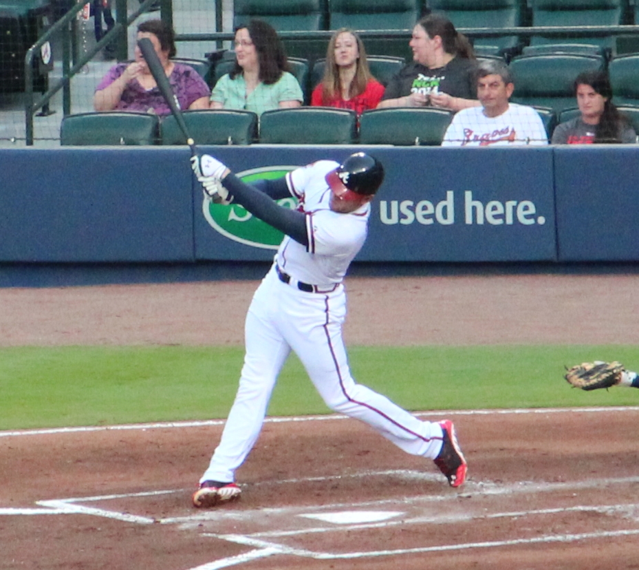 a man is holding a baseball bat on the field