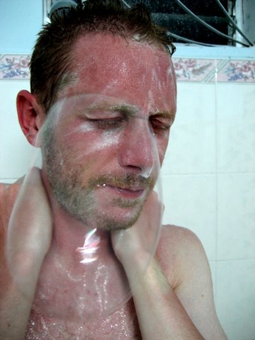 man with shower drops on his face and eyes