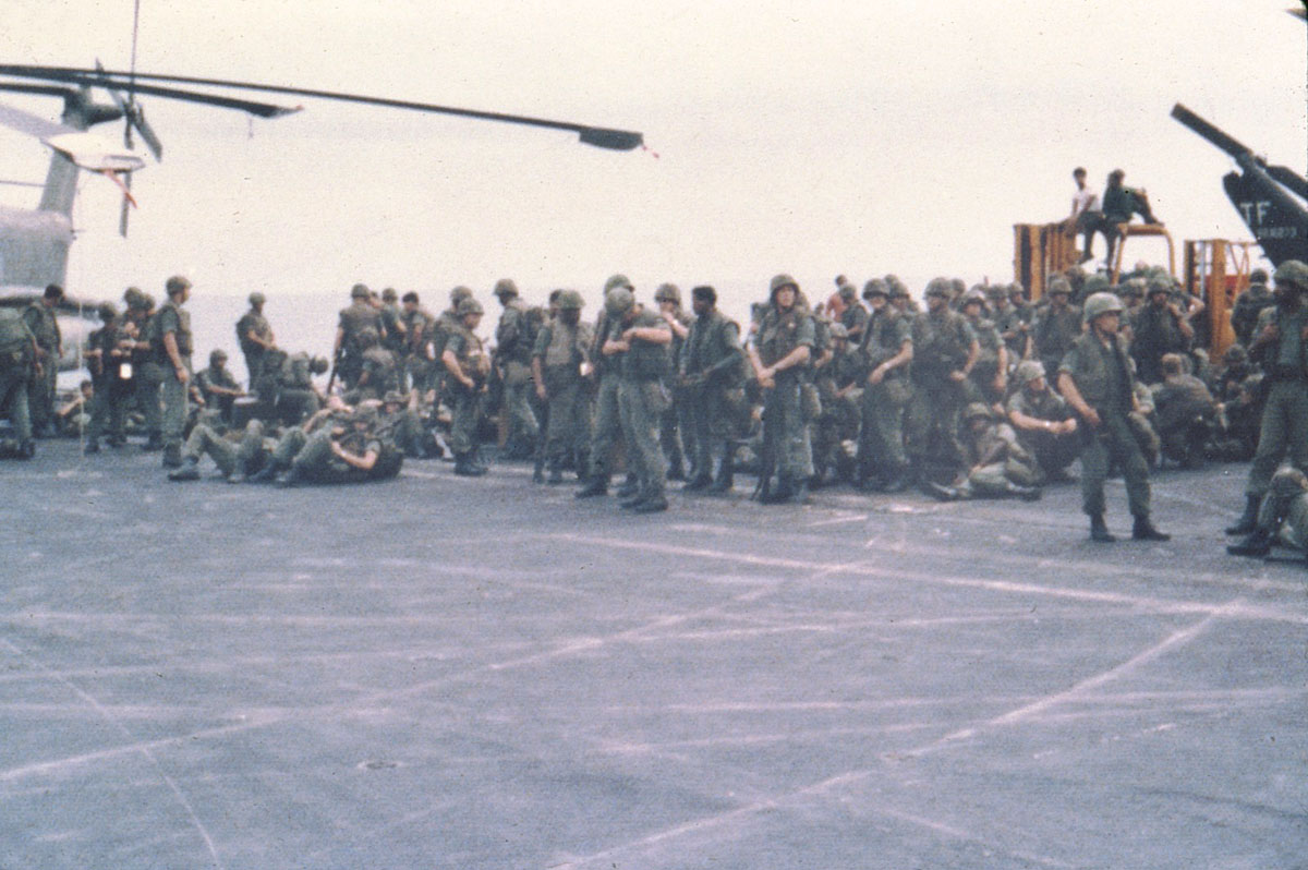 military personnel are gathered around and near an airplane