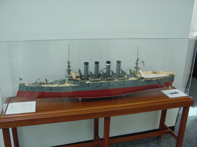a display case holding a model of the battleship