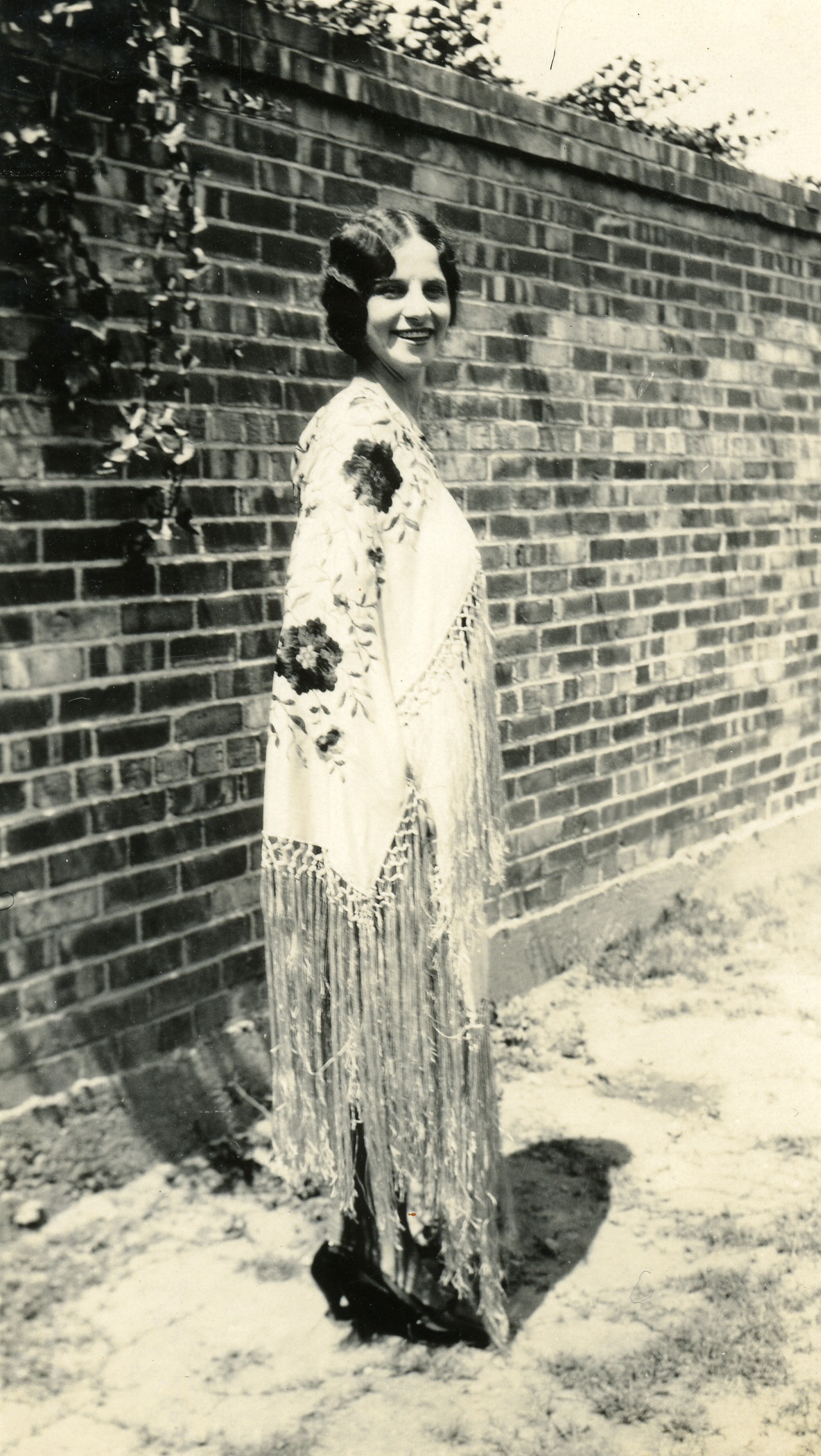 woman with face paint on standing near brick wall