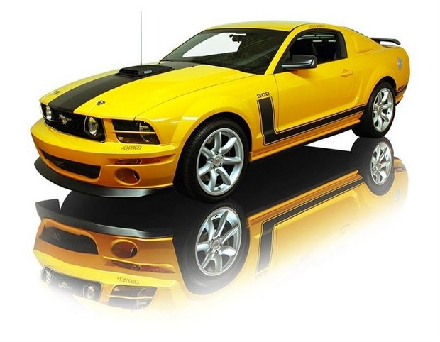 a large yellow mustang parked on top of a reflective surface