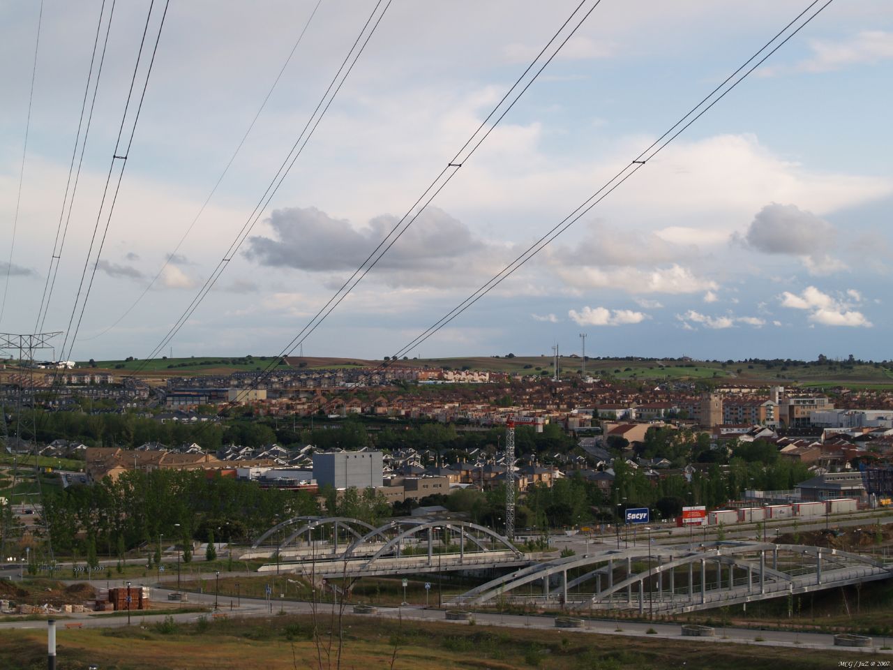 an overhead view of a city and bridge