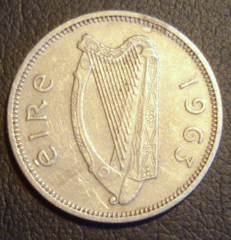 a large silver penny with an image of a harp on it