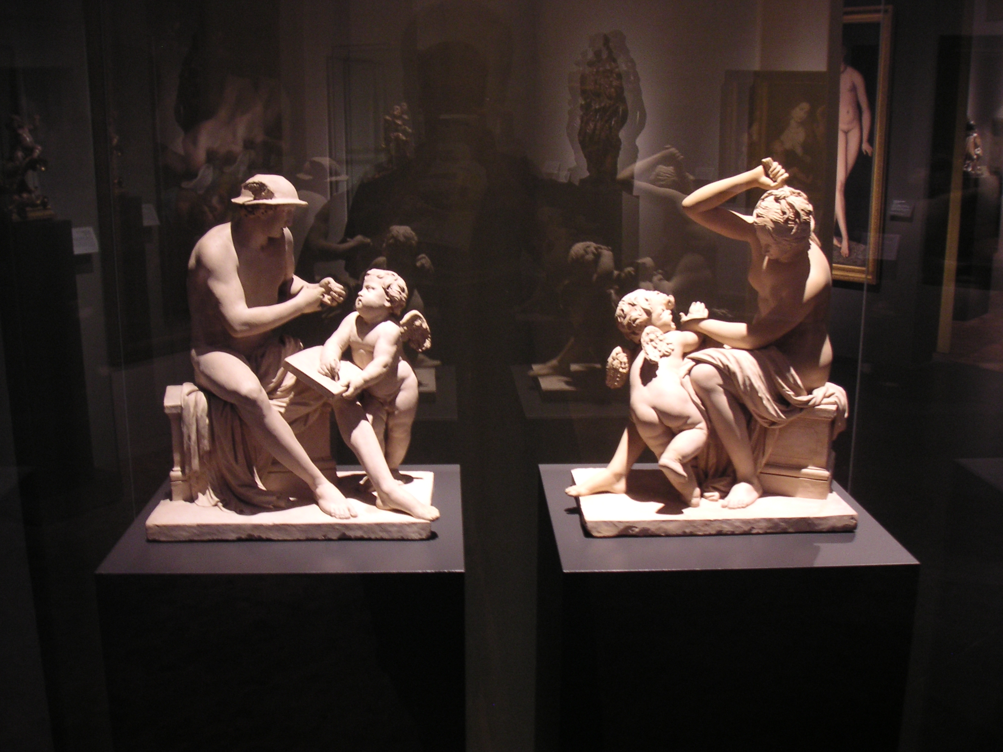 statues in a museum case on display of their past