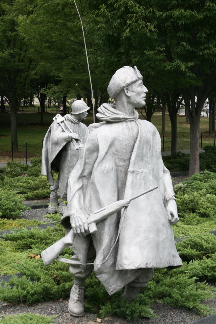 a statue of an american soldier with two spear and helmet