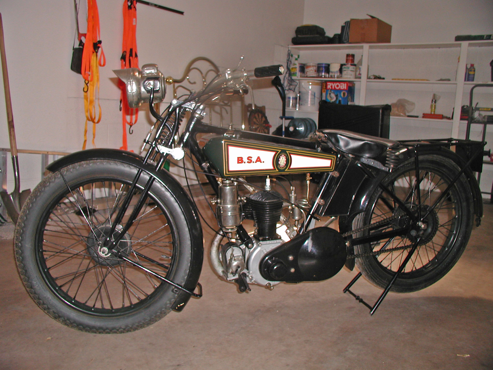 an old motorcycle sitting in a room next to a fire escape