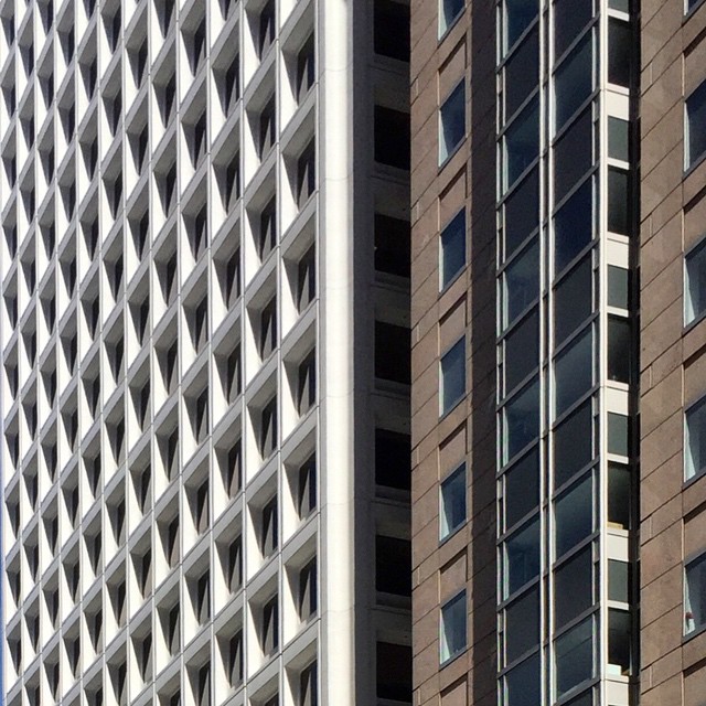 a large building with two very tall towers behind it