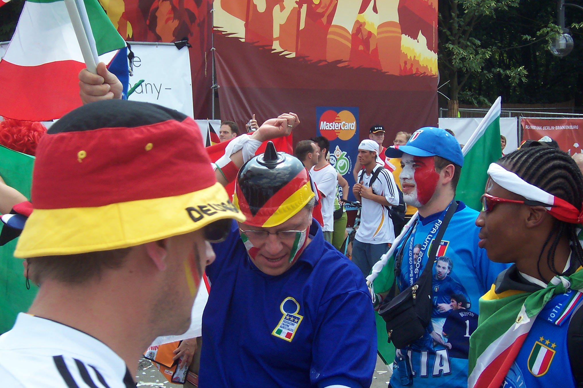 a group of men wearing colorful hats and holding flags