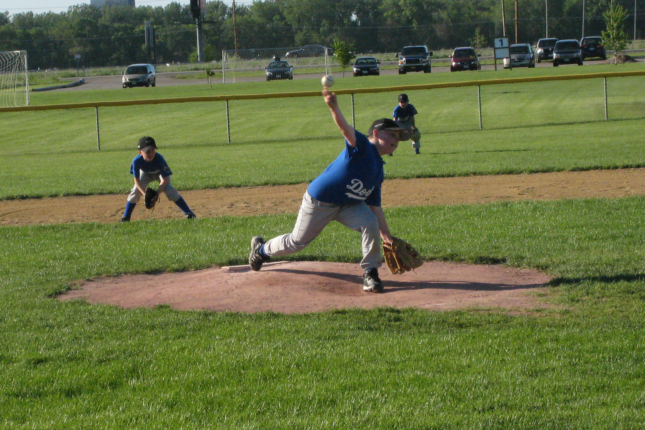 a person on a field throwing a baseball