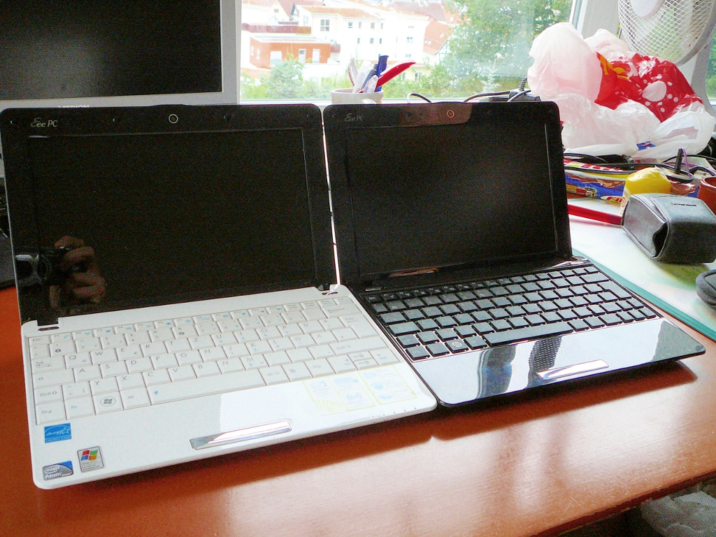 a desk with two laptop computers on it