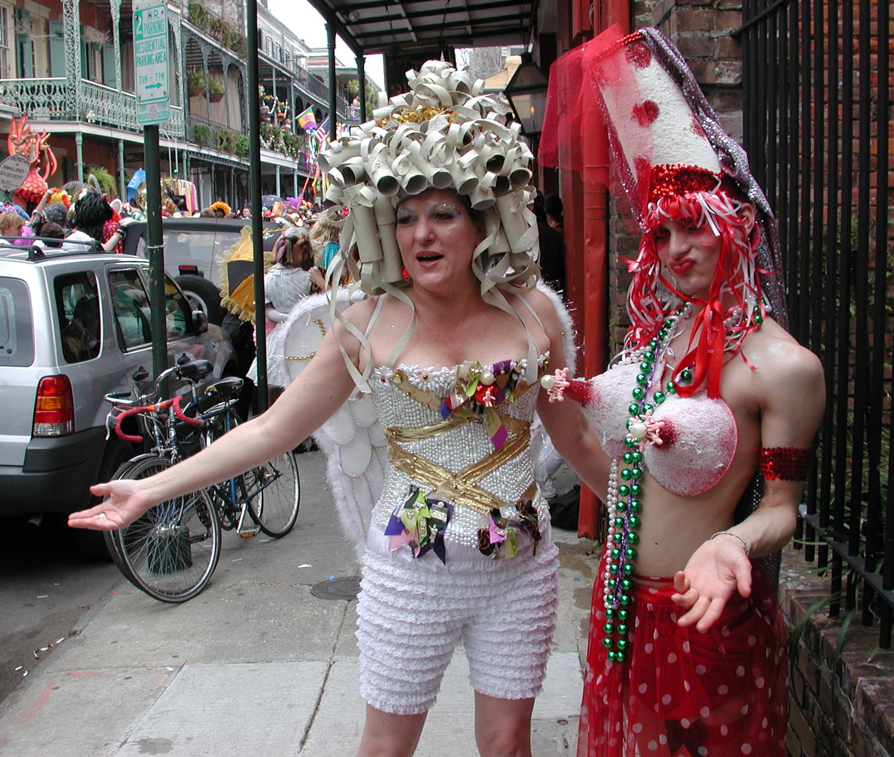 two women dressed in fancy costumes on a street