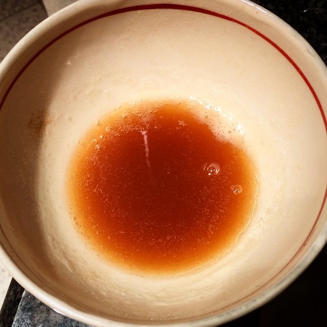 the brown liquid is sitting in a white bowl