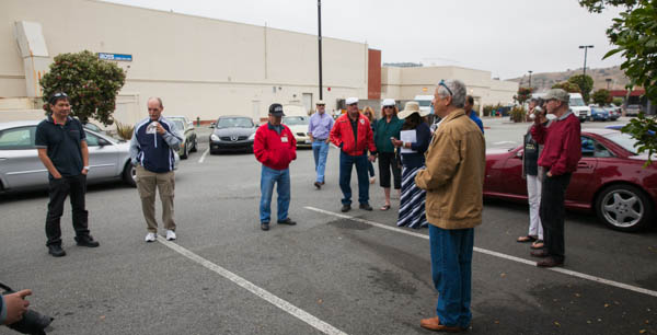 people standing around and waiting at an intersection