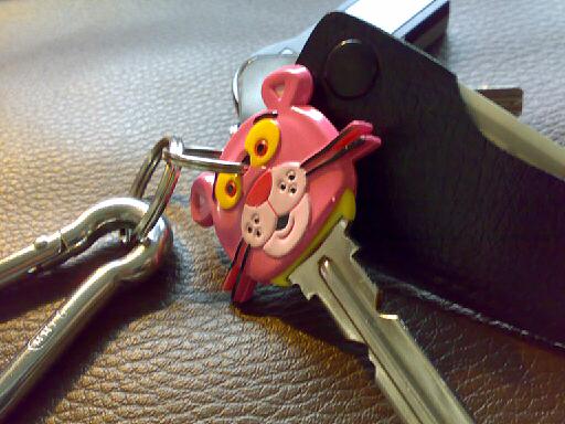 a pair of keys are attached to a piggy keychain