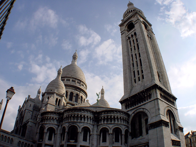 two gothic buildings standing side by side with a sky background