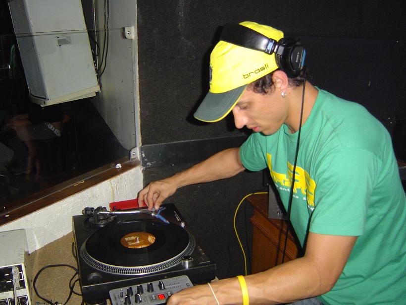 a man playing djs on his turntable and holding a cd