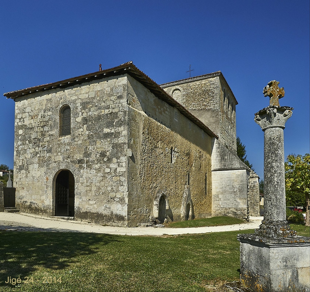 an old church with stone exterior and decorative column in front
