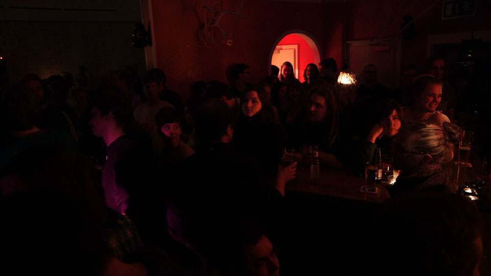 people at a party seated around in a dark room