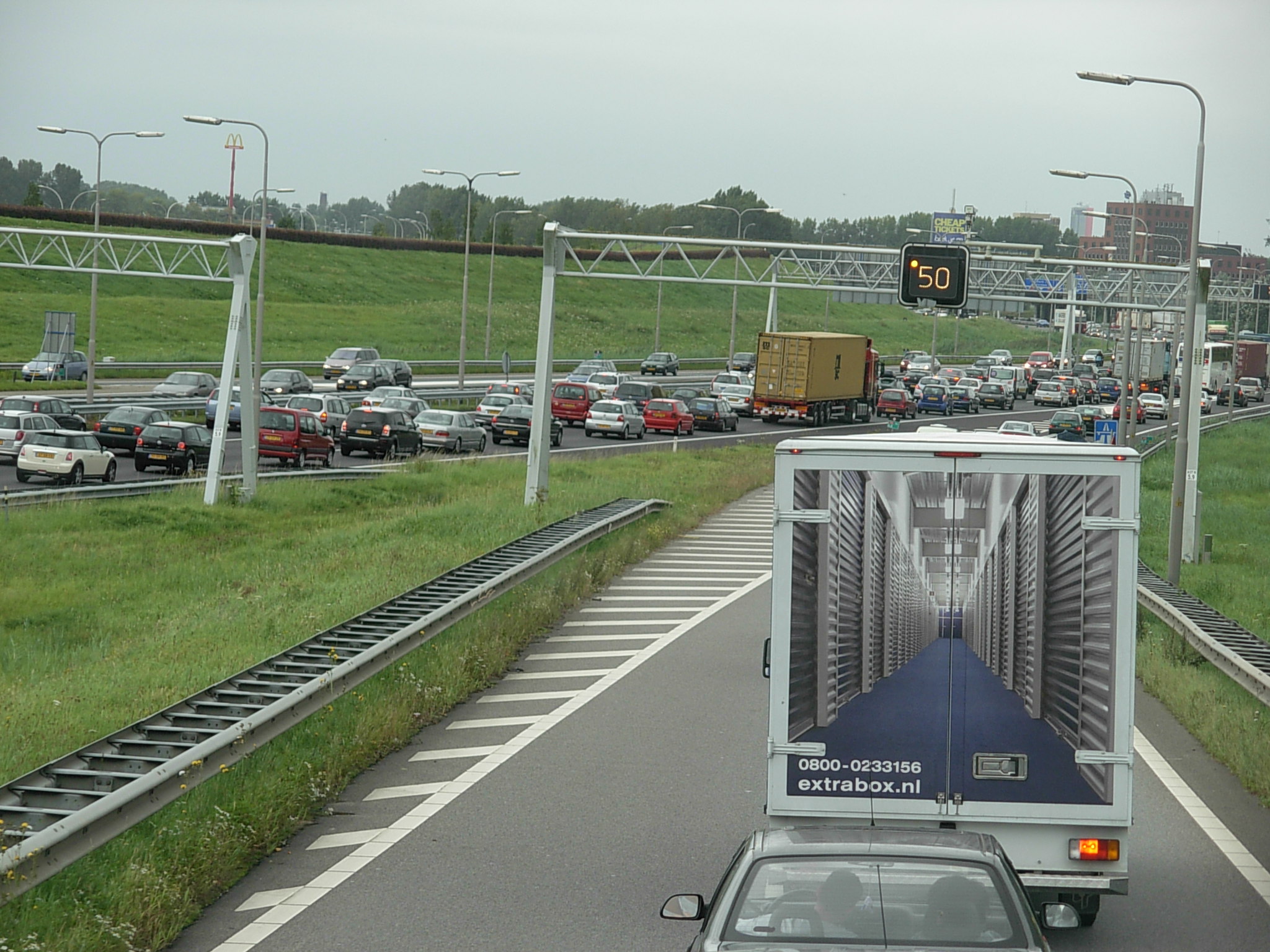 a car driving down the highway near an approaching traffic signal