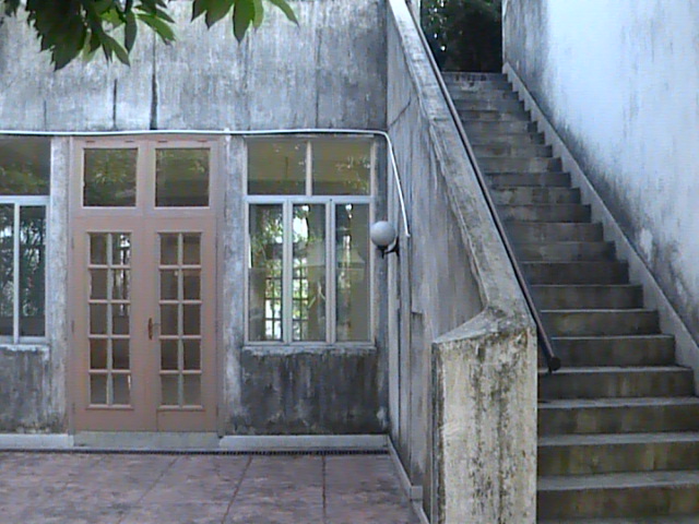 a staircase is in an old building near the door