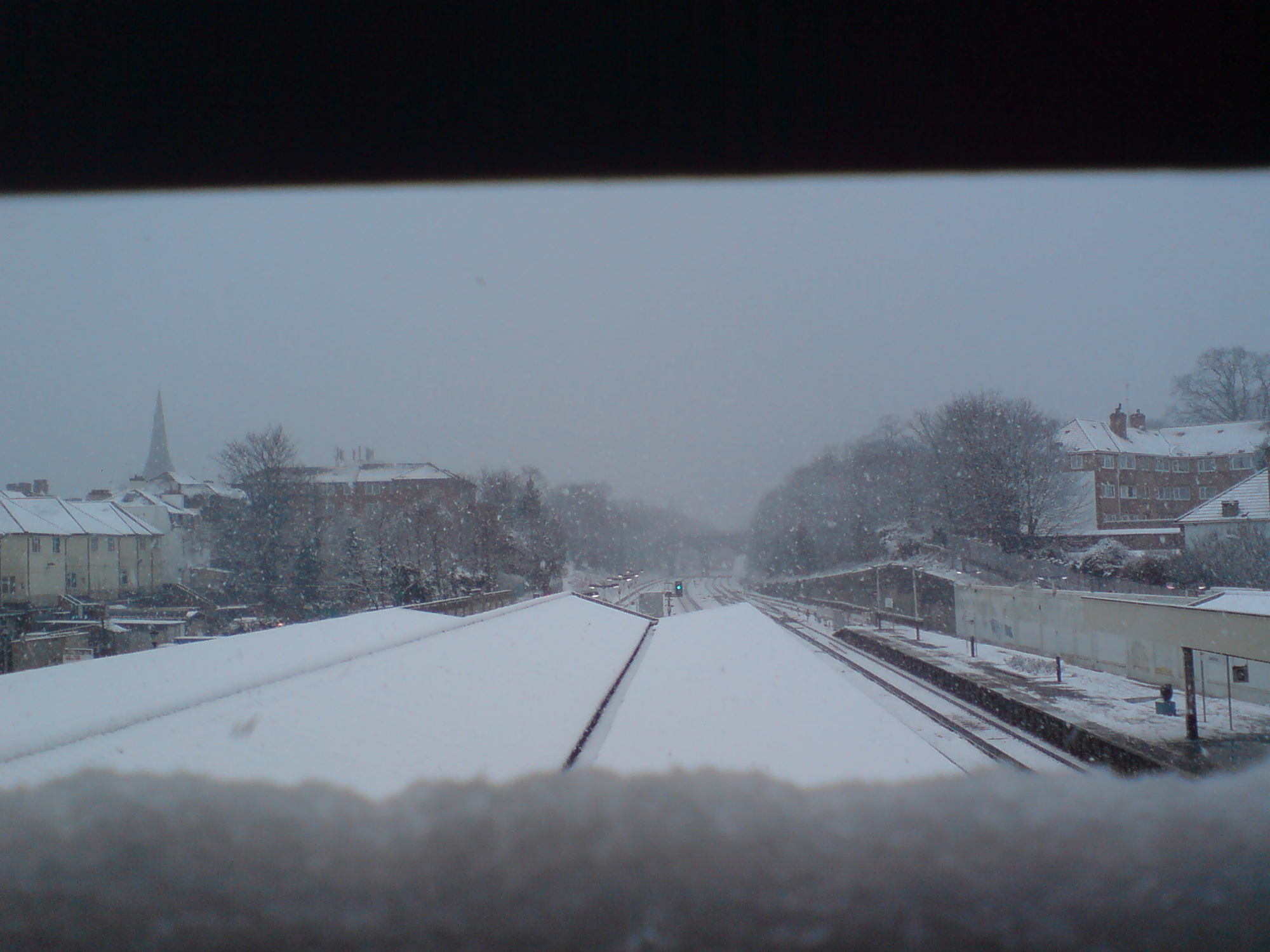 a view of a snowy town and train tracks