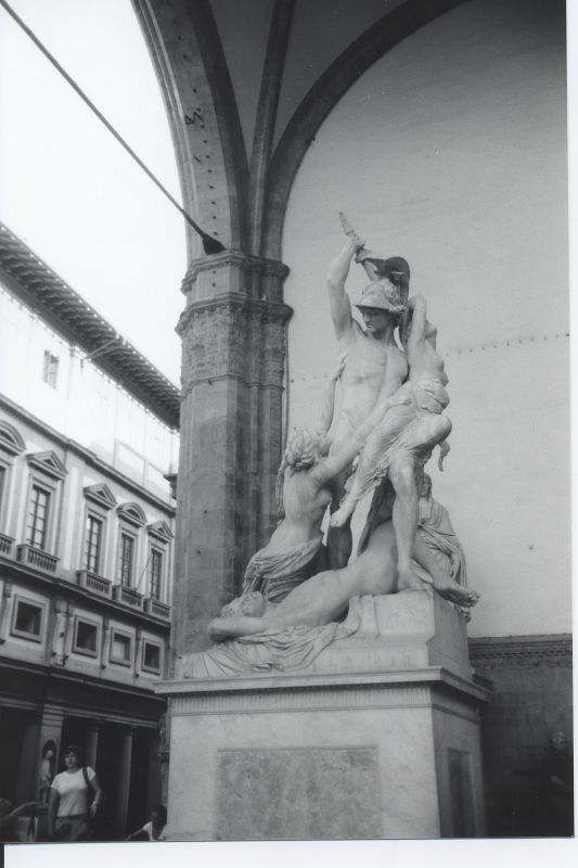 a statue of an person holding soing is placed on top of it