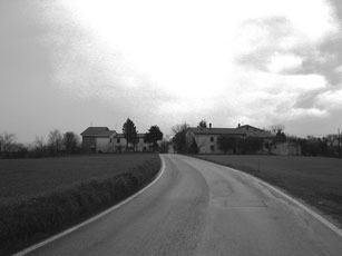 black and white po of rural road with house in distance