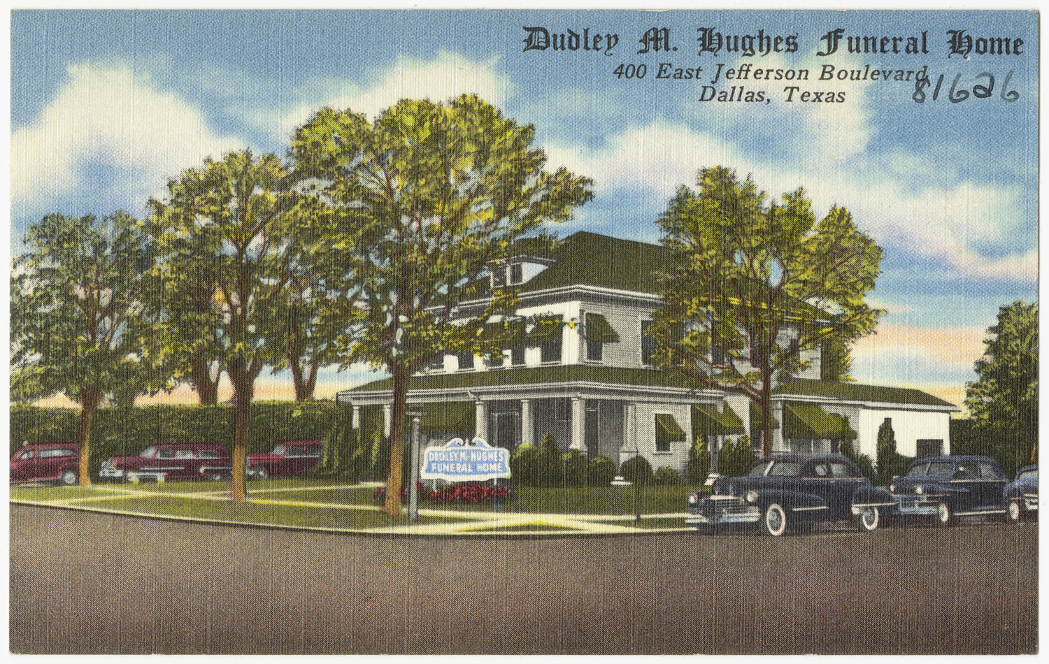 a postcard depicting an antique home with cars parked on the front