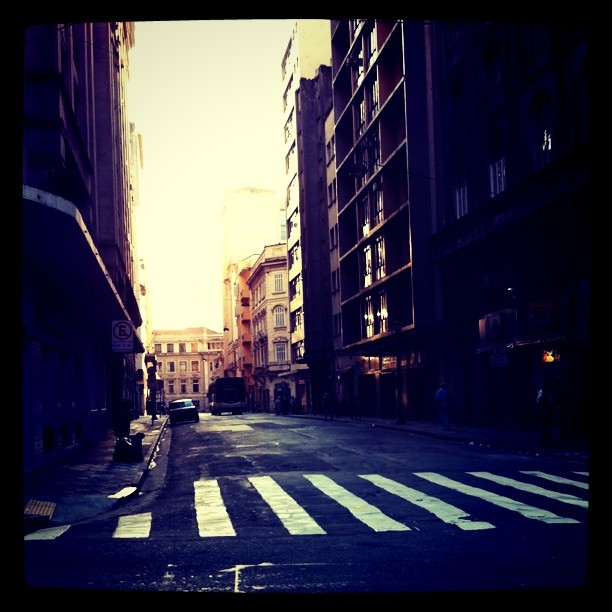 the sun is shining down on an empty city street