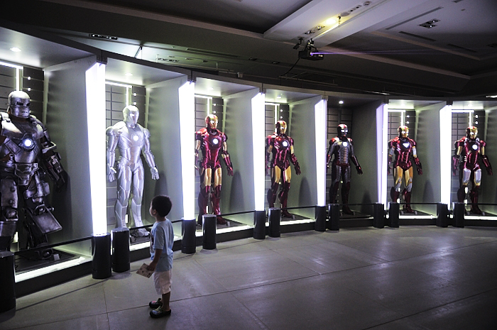 a child in a room that has multiple types of costumes on display