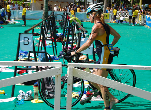 an athlete on her bike outside with other people