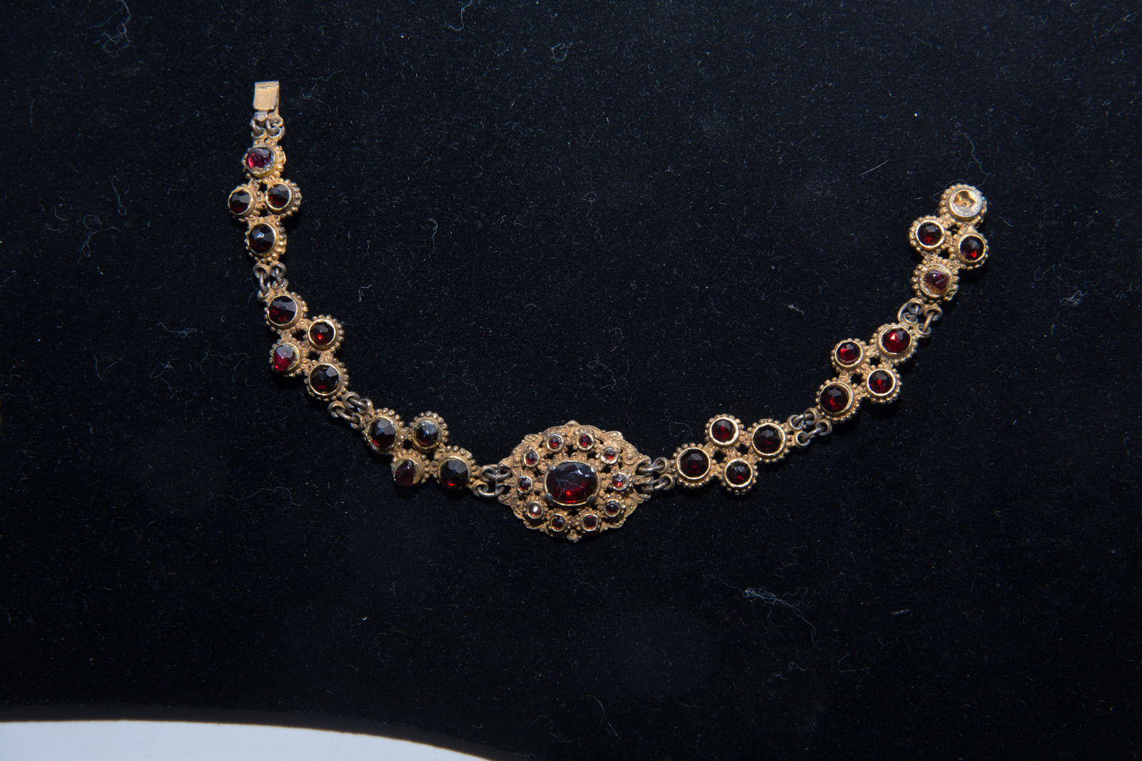 an antique necklace with gold tone and garnish stones